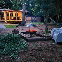 Evening in the garden of Holiday Home in Gasselte, Middle Drenthe, with cozy fire pit and comfortable seating.