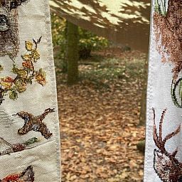 Cozy autumn decor in the Cottage in Papenvoort, vacation home in Drenthe, with embroidered curtains and woodland setting.