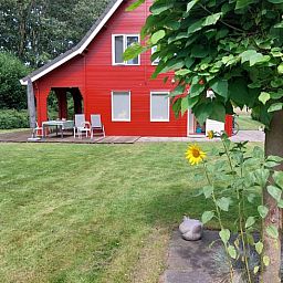 Gemuetliche Terrasse des Ferienhauses in Nieuw Balinge, Mittel-Drenthe, mit Blick auf einen gruenen Garten.