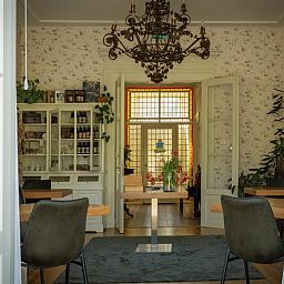 Cozy interior of a cottage in Veenhuizen, North Drenthe, with classic furnishings and an attractive chandelier.