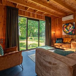 Cozy living room in Holiday Home in Dalerveen, Southeast Drenthe overlooking green nature.