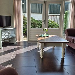 Cozy living room in Holiday Home in Dalerveen, Southeast Drenthe, with comfortable sofas and views of the garden.