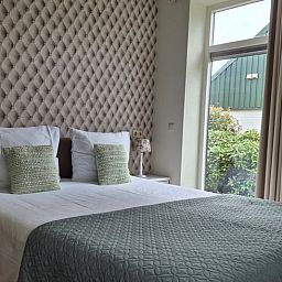 Attractive bedroom in Holiday Home in Dalerveen, Southeast Drenthe, with views of green surroundings and stylish furnishings.