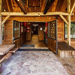 Welcoming entrance to the Cottage in Erm, a cozy vacation home in Southeast Drenthe, with a rustic wooden porch.