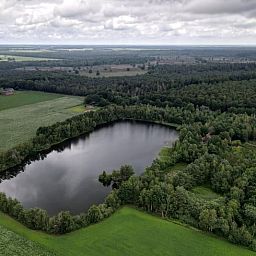 Luchtfoto van Vakantiehuisje in Odoornerveen, gelegen in de groene natuur van Zuidoost Drenthe met een prachtig meer en bosrijke omgeving.