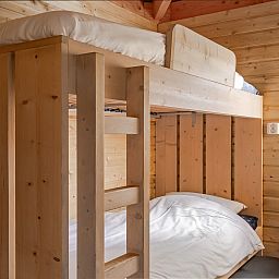 Cozy wooden bedroom in Hooiberglodge, a vacation home in Dwingeloo, Southwest Drenthe, perfect for a cozy overnight stay.