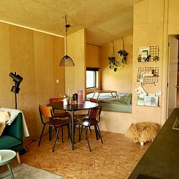 Dining and sleeping area in Holiday cottage in Vledder, Southwest Drenthe, with wooden interior.