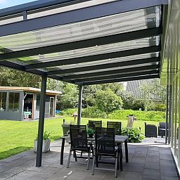 Atmospherically lit patio in Holiday Home in Wittelte, Southwest Drenthe, for evening meals outside.
