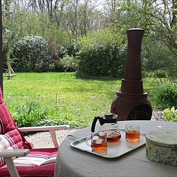Cozy porch of Huisje in Koekange, cottage in Southwest Drenthe, with tea and garden views.