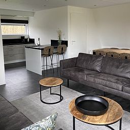 Spacious living room of detached house in Biddinghuizen, Eastern Flevoland, with modern furnishings and comfortable seating area.