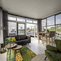 Helles Wohnzimmer im freistehenden Haus in Biddinghuizen mit Blick auf das Wasser, gelegen in Oostelijk Flevoland, Flevoland.