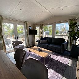 Interior of the detached house in Biddinghuizen, vacation home in Eastern Flevoland, with comfortable seating area and views of nature.