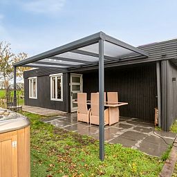 Modern barbecue and jacuzzi in the garden of Holiday home in Dronten, Eastern Flevoland, perfect combination for relaxation.
