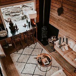 Cozy indoor area of Holiday Home in Zeewolde, Southern Flevoland, with wooden interior and comfortable seating area.