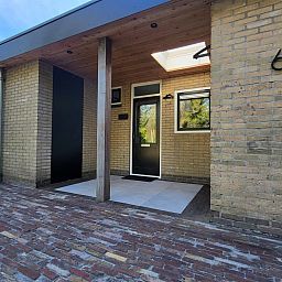 Ontspan op het ruime terras van vakantiehuis FR564 in Appelscha, omgeven door de serene Friese bossen van Friesland.