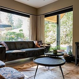 Cozy living room of Huisje in Appelscha, vacation home in the Frisian forests, overlooking the nature in Friesland.