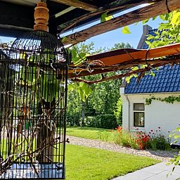 Gezellige veranda bij Vakantiehuisje in Ruigahuizen, omgeven door natuur in Friesland.
