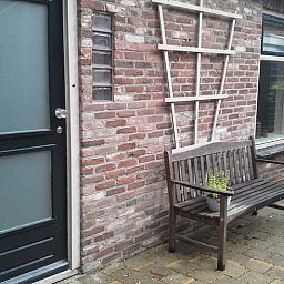 Entrance with wooden bench at Holiday Home in Steggerda, located in Friesland.