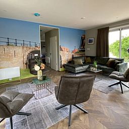 Stylish living room in the detached house in Hindeloopen, Friesland, with modern interior and views of green surroundings.