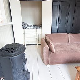 Cottage in Paesens, cozy sitting area with wood stove in Friesland.