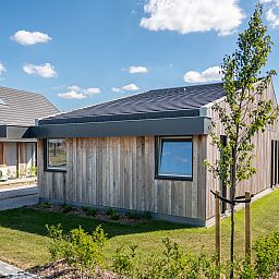 Gezellige woonkamer in 4-persoons woning 4L, Witmarsum, met uitzicht op het Friese platteland en comfortabele inrichting.