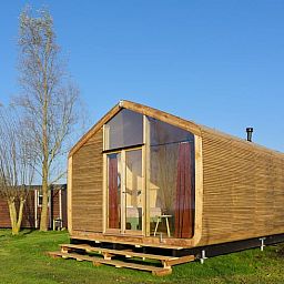 Ferienhaus in Broek, Friesland, bietet ein modernes Holzhaus in der friesischen Landschaft mit grosser Veranda und schoener Aussicht.