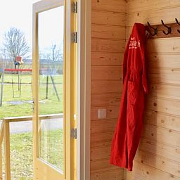 Entrance of cottage in Oldeholtwolde overlooking the green surroundings of the Frisian countryside.