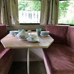 Cozy indoor area of Holiday Home in Dreumel, Gelderland with comfortable seating area and view of green surroundings.