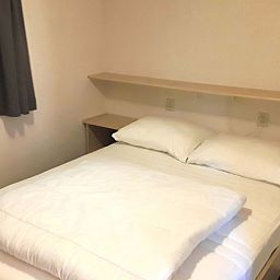 Gezellige slaapkamer in Boshuisje 'de Wielewaal', vakantiehuis in Winterswijk, Achterhoek, Gelderland, omringd door rustgevende natuur.