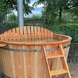 Geniet van de rust in de houten hottub bij Vakantiehuisje in Ruurlo, gelegen in de groene Achterhoek, Gelderland.