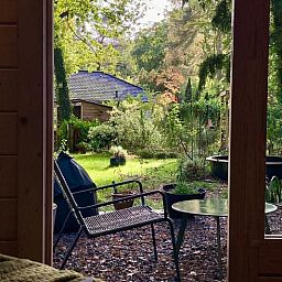 View of the garden from Holiday home in Lochem, Achterhoek, with green surroundings.