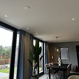 Light-filled interior of Chalet in Lochem with large windows in Achterhoek, Gelderland.