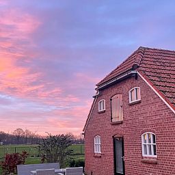 Winter garden at Holiday home in Geesteren, Achterhoek. Enjoy the serene view of snow-covered fields and nature in Gelderland.