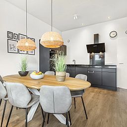 Dining area of De Vlinderhoeve vacation home in Kring van Dorth with stylish kitchen.