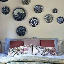 Attractive bedroom in Cottage in Voorst, Oude IJsselstreek, with artistic wall decorations and cozy furnishings, Achterhoek, Gelderland.