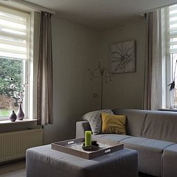 Cozy living room in Holiday home in Winterswijk Corle overlooking the green surroundings in Achterhoek, Gelderland.