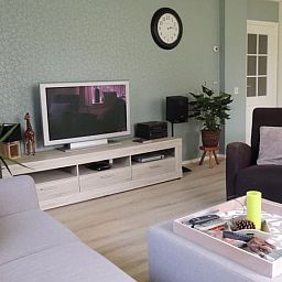 Modern living room with TV in Holiday home in Winterswijk Corle, perfect for relaxation in Achterhoek, Gelderland.