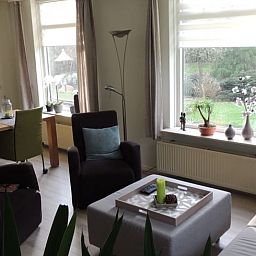 Dining and sitting area in Holiday home in Winterswijk Corle, overlooking the garden in Achterhoek, Gelderland.