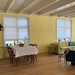 Cozy living room in Holiday home in Corle, Winterswijk Corle, with dining area and sitting area, perfect for family gatherings.