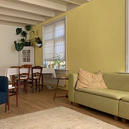 Comfortable sitting area in Holiday home in Corle, Winterswijk Corle, with bright interior and wooden floor in the Achterhoek.