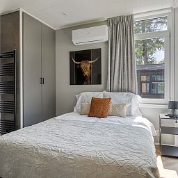 Cozy bedroom of Veluwehoeve 4 persons MIVA in Ede, Veluwe, with air conditioning and soothing decor.