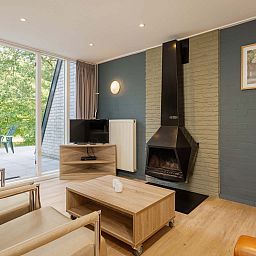Cozy living room with fireplace in detached house Hoenderloo, Veluwe, Gelderland.