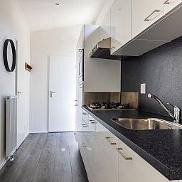 Kitchen with sleek finish in detached house in Hoenderloo, Veluwe, Gelderland.
