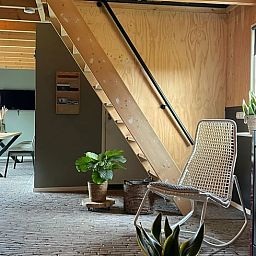 Cozy interior of Holiday Home in 't Harde, Veluwe, with wooden interior and sitting area.