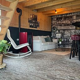 Stylish living room in Holiday Home in 't Harde, Veluwe, Gelderland, with comfortable seating area.