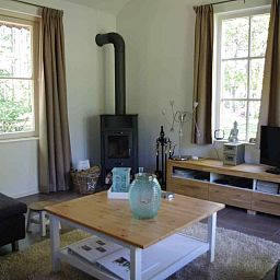 Living room with wood stove in vacation home DG1276, Putten, Veluwe, Gelderland.