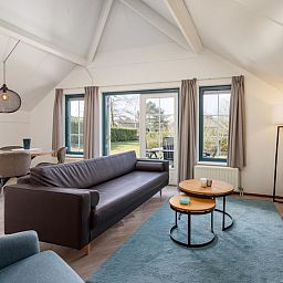 Cozy living room of Veluwse Hoevewoning 4 in Putten, Veluwe. Comfortable vacation home overlooking the green surroundings of Gelderland.