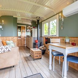 Dining and sitting area in Holiday Home in Wezep/Oldebroek, ideal for a relaxing Veluwe vacation.