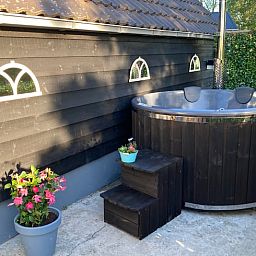 Private hot tub at Holiday home in Wezep Oldebroek, Veluwe, Gelderland for ultimate relaxation.