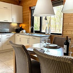 Gemuetliche Kueche im Ferienhaus in Voorthuizen, Veluwe, mit Blick auf die Natur Gelderlands und einem stimmungsvollen Essbereich.